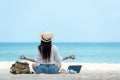 Lifestyle freelance woman relax and sitting meditation on the beach.ÃÂ 